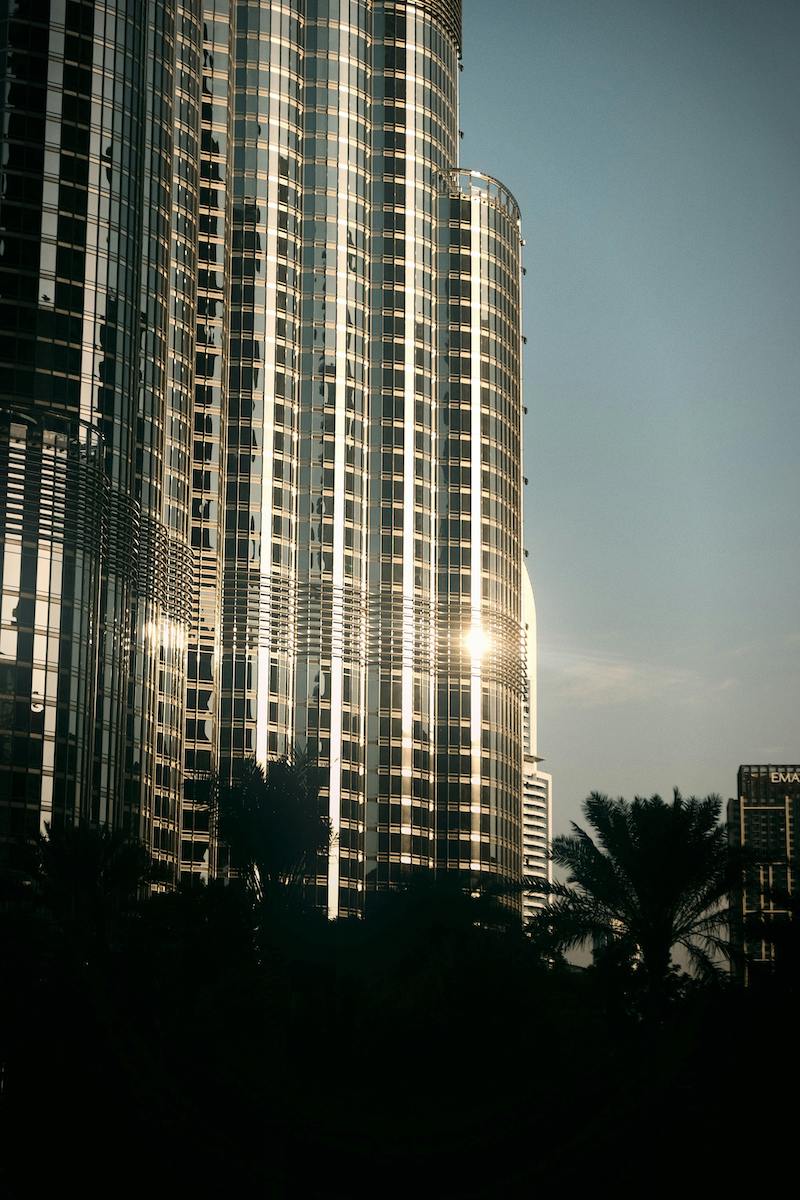 Sunlight glinting off the modern skyscrapers of Dubai, capturing the vibrant skyline of the city where many of our family office clients are based.