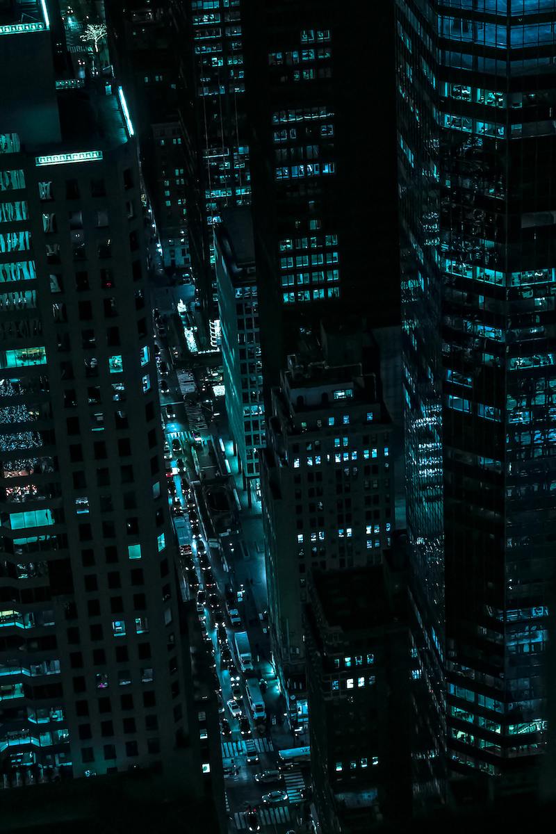 Nighttime skyline of New York City glowing with illuminated skyscrapers, representing the global financial hub where many of our family office clients are headquartered.
