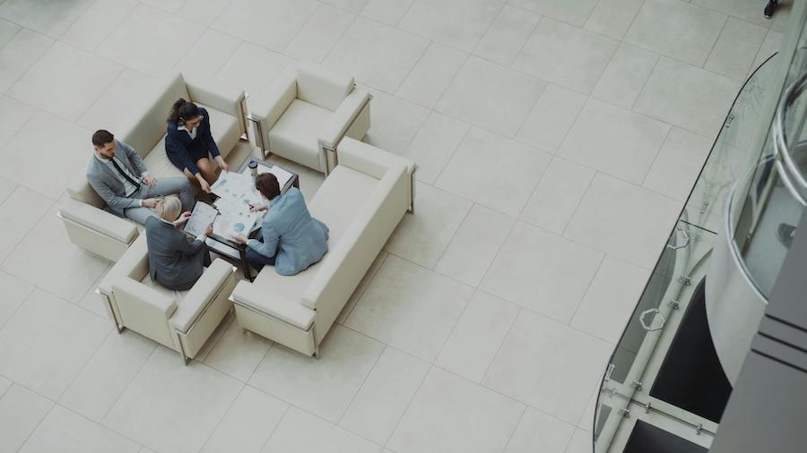 A meeting of family office staff in an office.